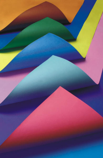 Bright folded origami papers in blue, pink, green, and yellow create layered geometric peaks with smooth gradients and crisp edges across the frame.
